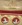 A set of boxed buttons with the portrait of a period woman on a red enamel background